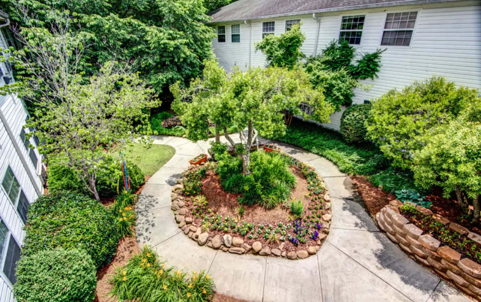 Lush garden with pathways and flower beds. Peaceful atmosphere.