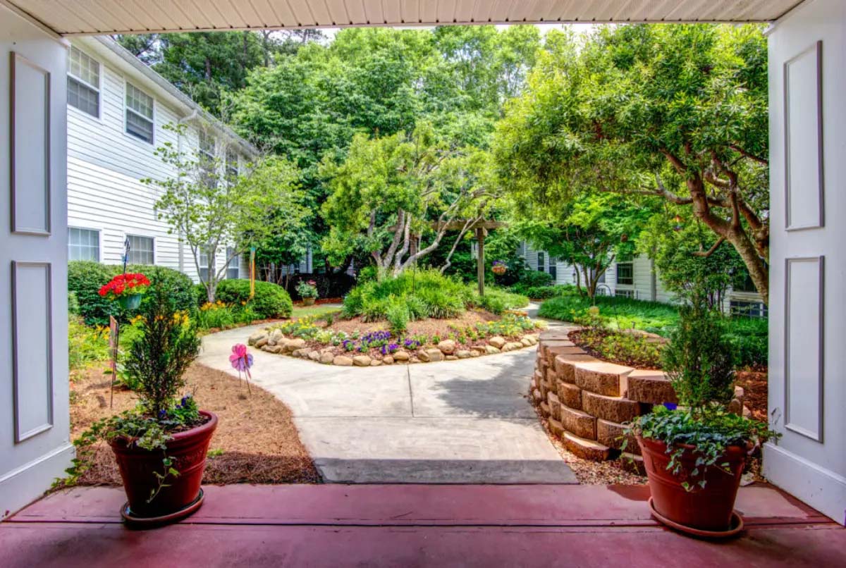 View of a landscaped garden through an open doorway.